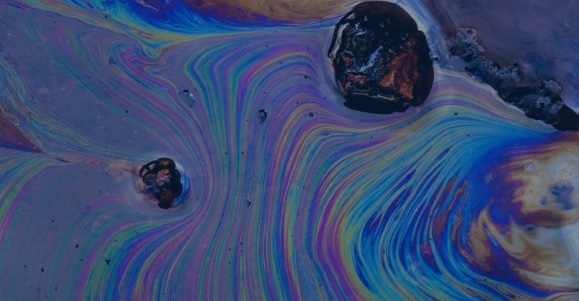 Rainbow colors of oil spilled on water