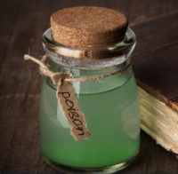 Jar with green poison next to book
