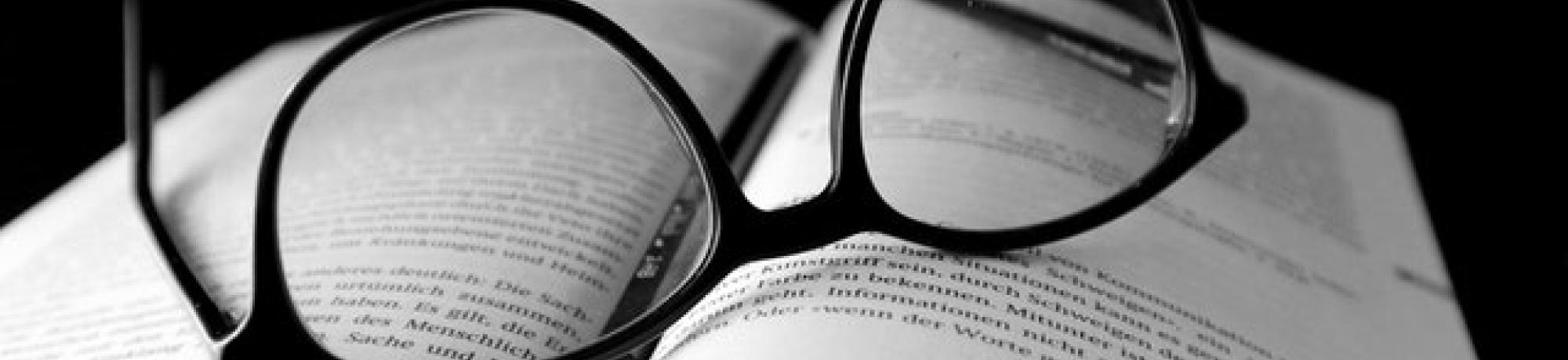 Black glasses on book:Photo by Manfred Hofferer from Pexels